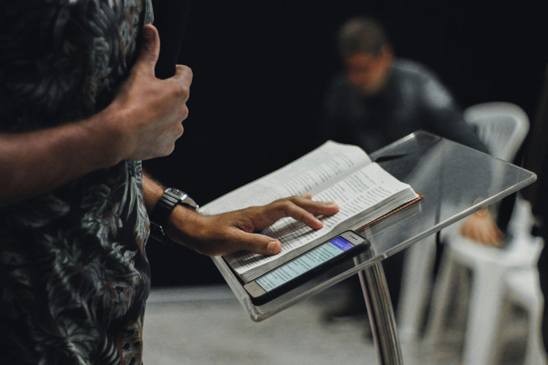 Image montrant une bible ouverte posé près d'un smartphone Image montrant une bible ouverte posé près d'un smartphone